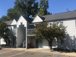 Wayne apartment for rent - Two story grey apartment building at Greyberry Apartments. There is a patio for the first-floor homes and a balcony on the second floor.  The breezeway has a staircase in it and is in the middle of the building.  There are two trees on either side of the breezeway and a sidewalk is in front of the building.