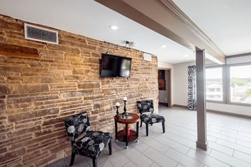 Jackson apartment for rent - A living room with a brick wall and a television mounted on it.