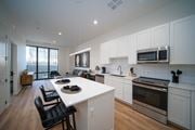 Detroit apartment for rent - an open kitchen and living room with a white counter top