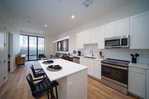 Detroit apartment for rent - an open kitchen and living room with a white counter top