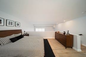 Ann Arbor apartment for rent - A bedroom with a bed, nightstand, and a dresser at The George, Ann Arbor, MI