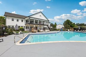 Indianapolis apartment for rent - A large white house with a pool in front.