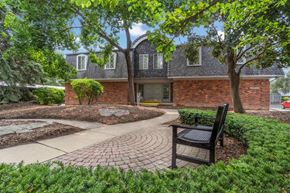Royal Oak apartment for rent - a brick house with a brick walkway and a bench
