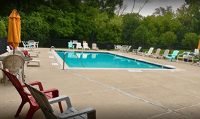 Wayne apartment for rent - a swimming pool with chairs and chairs around it