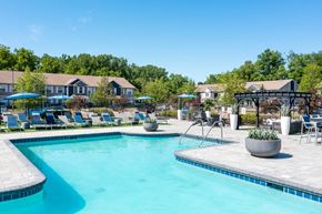 Lansing apartment for rent - a resort pool with slides and buildings in the background