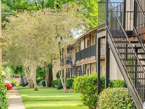 Alexandria apartment for rent - a row of apartment buildings with a lawn and trees