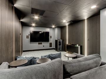 Oklahoma City apartment for rent - A modern living room with grey couches and a flat screen TV.