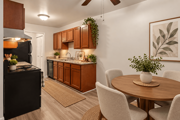 Oak Park apartment for rent - A kitchen with brown cabinets and a black refrigerator.