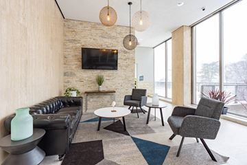 Detroit apartment for rent - a living room with a leather couch and a television