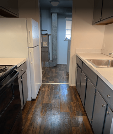 Redford apartment for rent - an empty kitchen with a sink and a refrigerator