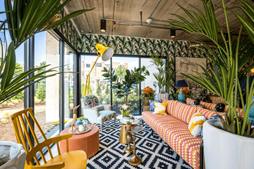 Detroit apartment for rent - a living room filled with furniture and plants