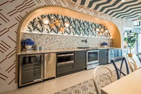 Detroit apartment for rent - a kitchen with stainless steel appliances and a geometric wallpaper at City Club Apartments Lafayette Park, Michigan 48207