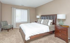 Southfield apartment for rent - a bedroom with a bed and a dresser and a window