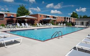 Bedford apartment for rent - A swimming pool surrounded by sun loungers and apartment buildings.