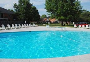 Indianapolis apartment for rent - a large swimming pool with white chairs around it