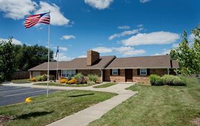 Indianapolis apartment for rent - A building with a flag on a pole in front of it.
