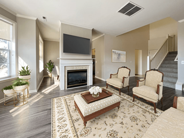 Troy apartment for rent - a living room with a fireplace and a tv above it