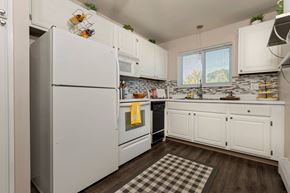 Royal Oak apartment for rent - a kitchen with white cabinets and a refrigerator at Village Club of Royal Oak, Royal Oak Michigan