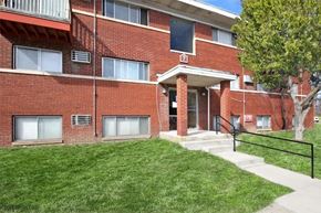 Indianapolis apartment for rent - A red brick building with a black railing in front.