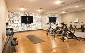 Duluth apartment for rent - A gym with exercise bikes and motivational wallpaper.
