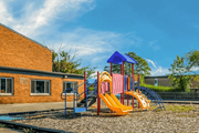 Oak Park apartment for rent - A playground with a yellow slide and a blue and pink structure.
