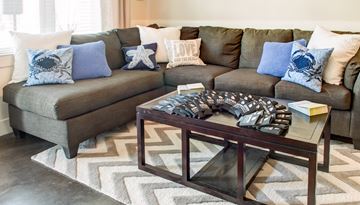 Corpus Christi apartment for rent - A living room with a grey couch and a coffee table.