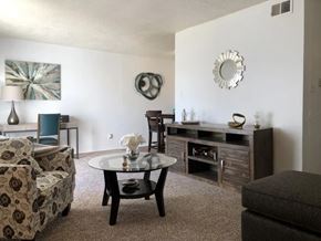 Indianapolis apartment for rent - A living room with a sofa, a chair, a coffee table, and a painting on the wall.