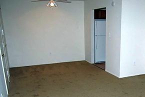 Romulus apartment for rent - Living and dining area with beige carpet and ceiling fan