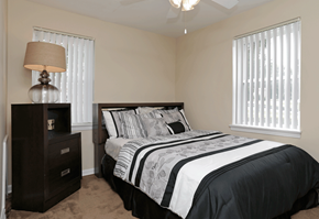Euclid apartment for rent - Black and white bedspread next to dresser