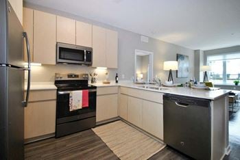 A kitchen with a stove top oven next to a sink