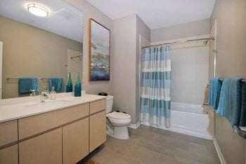 A bathroom with a sink toilet and shower