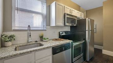 Detroit apartment for rent - A kitchen with a sink, stove, and refrigerator.