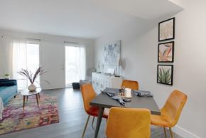 St. Louis apartment for rent - A dining room with a table set for two and a sofa in the background.