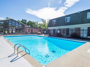 St. Louis apartment for rent - A large swimming pool in front of a building.