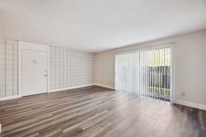 Florissant apartment for rent - A room with wooden flooring and a white door.