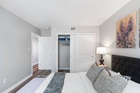 Indianapolis apartment for rent - A bedroom with a large bed and a painting on the wall.