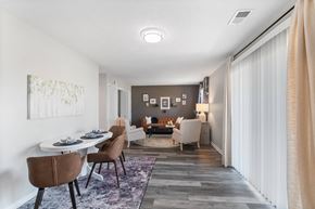 Indianapolis apartment for rent - A dining room with a white table and brown chairs.