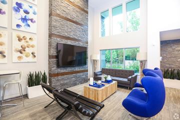 Lawrence apartment for rent - A living room with a blue chair and a fireplace.