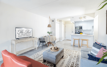 Southfield apartment for rent - A living room with a red chair and a sign that says "The Park at Trowbridge Senior Living".