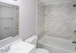 Indianapolis apartment for rent - A white toilet sits next to a sink in a bathroom.