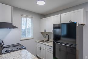 Cincinnati apartment for rent - A kitchen with a stove, sink, and refrigerator.