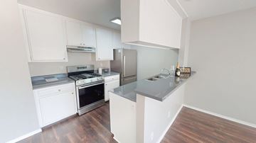 North Hollywood apartment for rent - A kitchen with white cabinets and a stainless steel refrigerator.