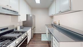 North Hollywood apartment for rent - A kitchen with white cabinets and a stainless steel refrigerator.
