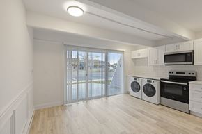Toms River triplex for rent - A kitchen with white cabinets and a microwave above the stove.