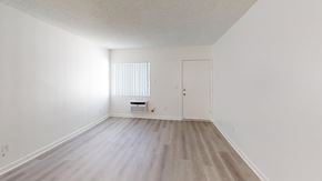 Granada Hills apartment for rent - A room with a white door and a window with blinds.