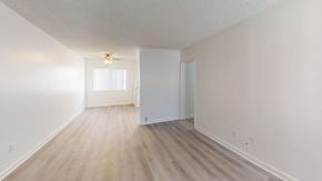 Granada Hills apartment for rent - A room with a light brown floor and white walls.