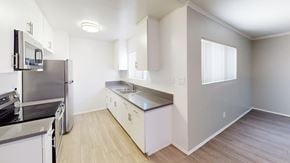 Granada Hills apartment for rent - A kitchen with a stove top oven and a dishwasher.