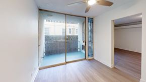 Los Angeles apartment for rent - A room with a ceiling fan and sliding glass doors.