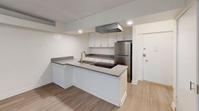 Los Angeles apartment for rent - A kitchen with a refrigerator, sink, and cabinets.