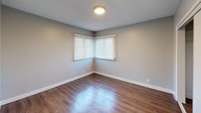Inglewood apartment for rent - A room with wooden flooring and a window with blinds.